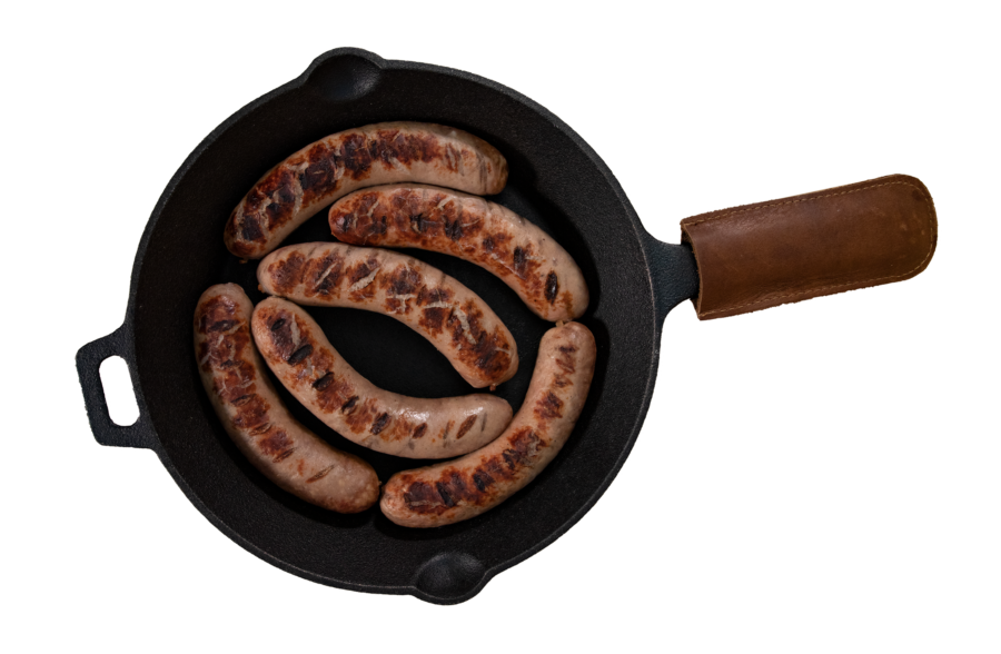 A cutout of Grand Champion brats in a cast iron skillet
