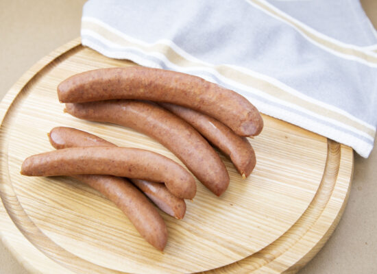 natural casing wieners on a cutting board